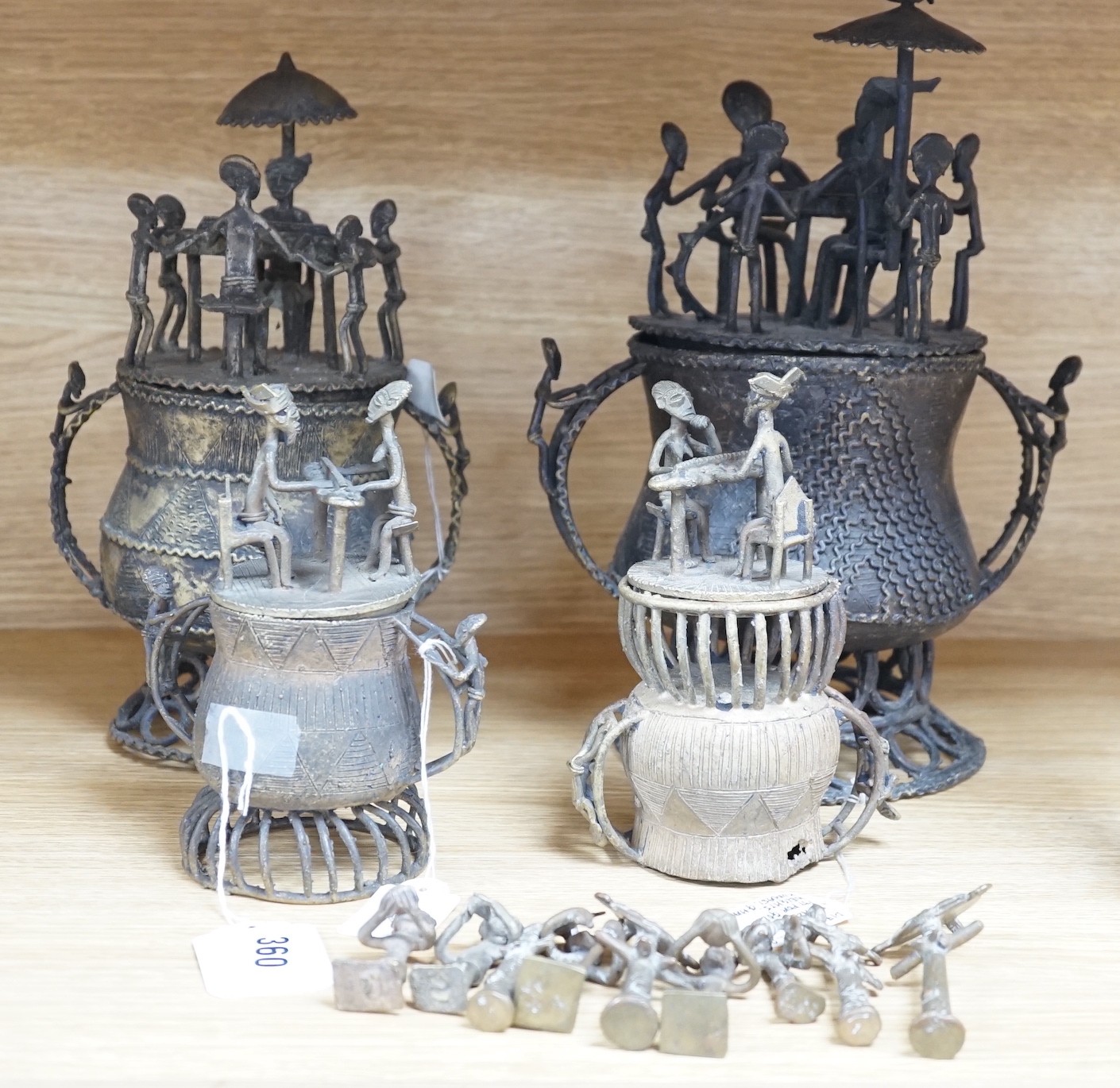 A collection of four Ashanti bronze figural vessels, and nine single figures, tallest 29cms high